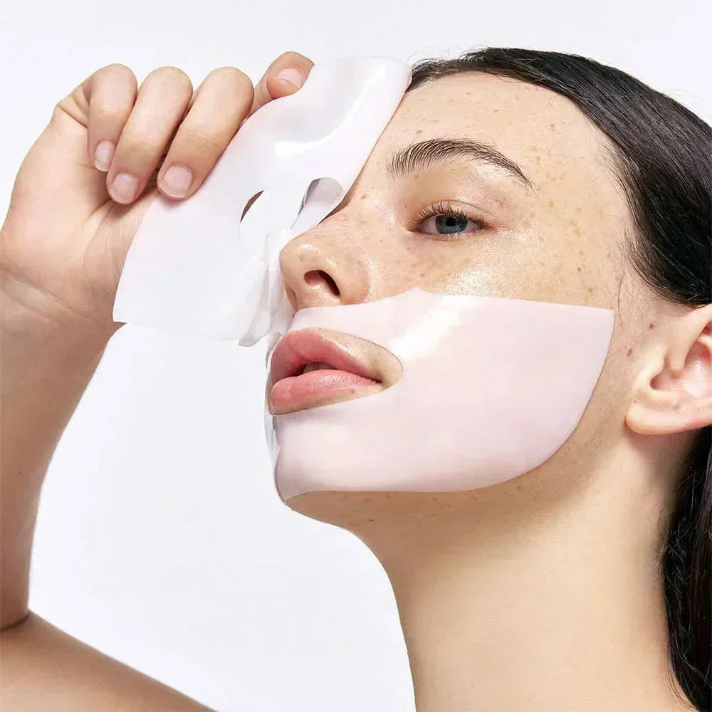Woman applying collagen sheet mask for hydrated, plump and glowing K-beauty skin
