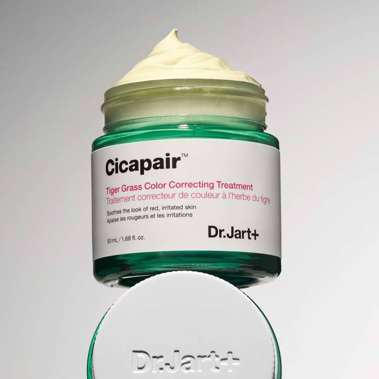 Person applying Dr.Jart+ Cicapair Tiger Grass Color Correcting Treatment on face for redness coverage