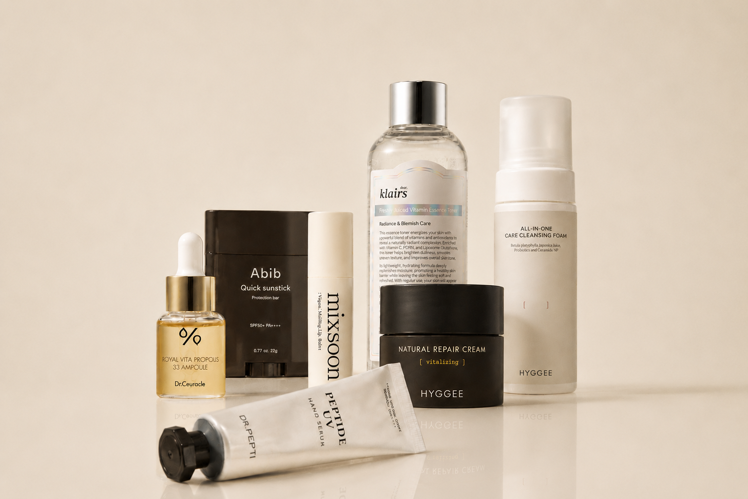 Korean skincare routine featuring Hyggee Natural Repair Cream, Dear Klairs Freshly Juiced Vitamin Essence Toner, Dr.Ceuracle Royal Vita Propolis 33 Ampoule, Abib Quick Sunstick and Mixsoon Bean Sun Stick.