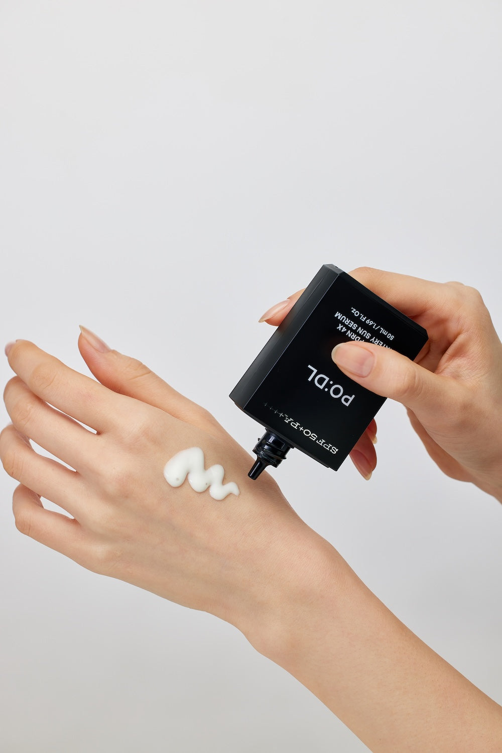 Lightweight watery texture of PO:DL sun serum SPF50 on skin